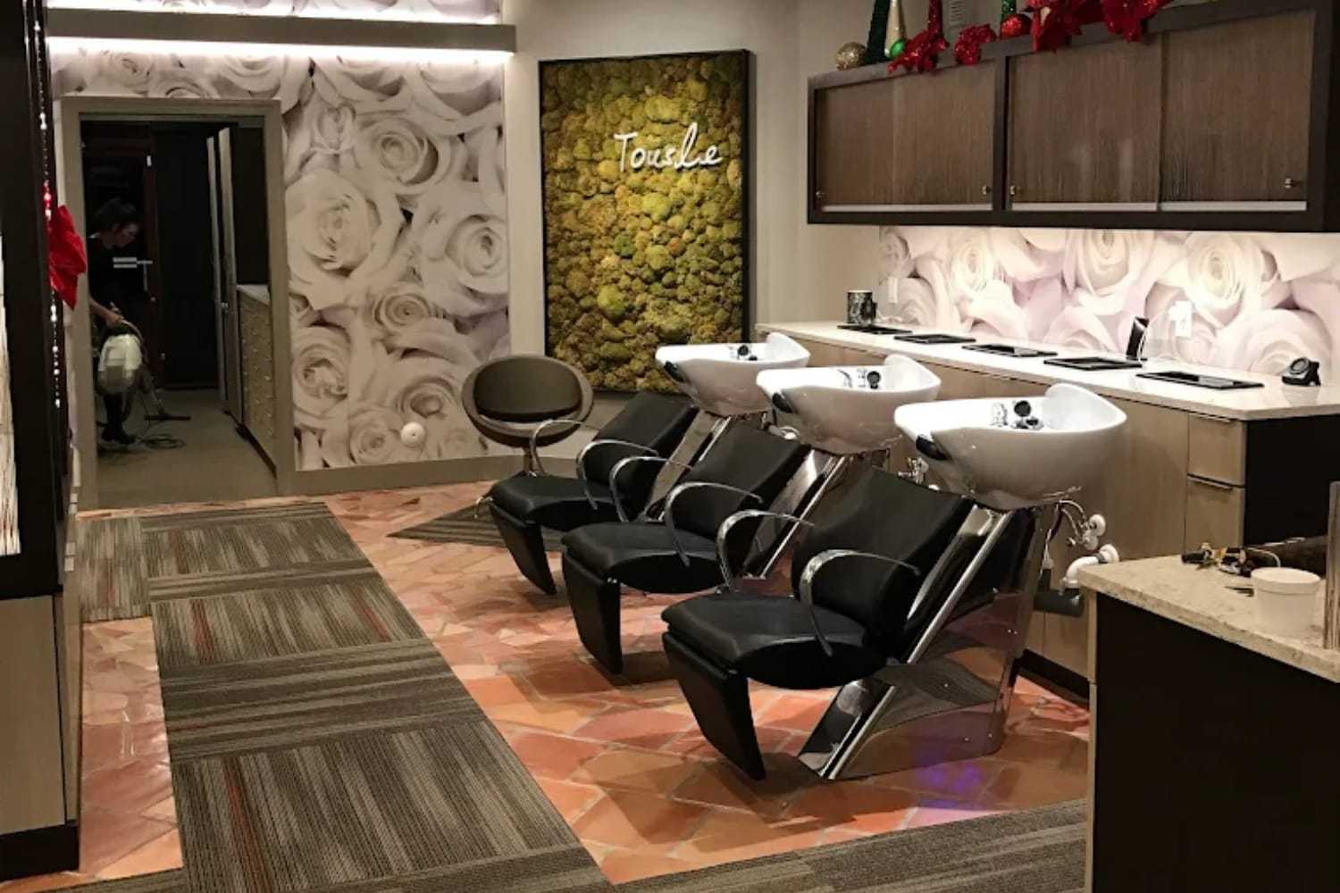 Modern salon with stylish wash stations and floral decor.