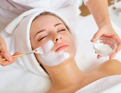 Woman receiving facial treatment