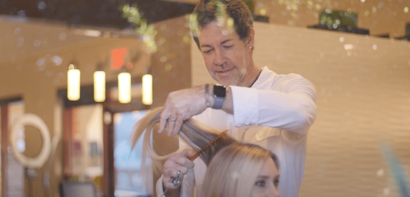 Jay Dupre working on woman's hair