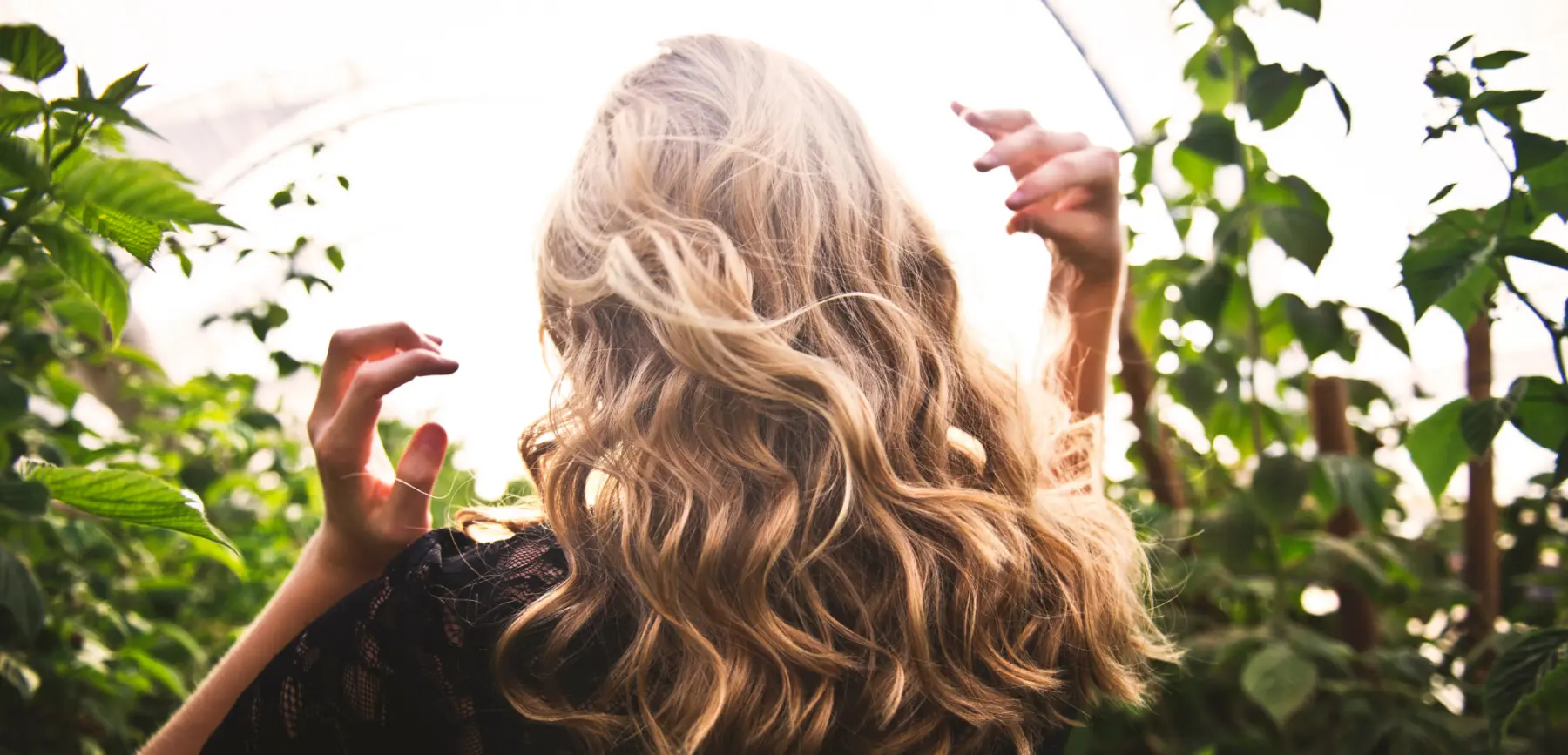 Woman surrounded by greenery | Dupre's Salon and Day Spa